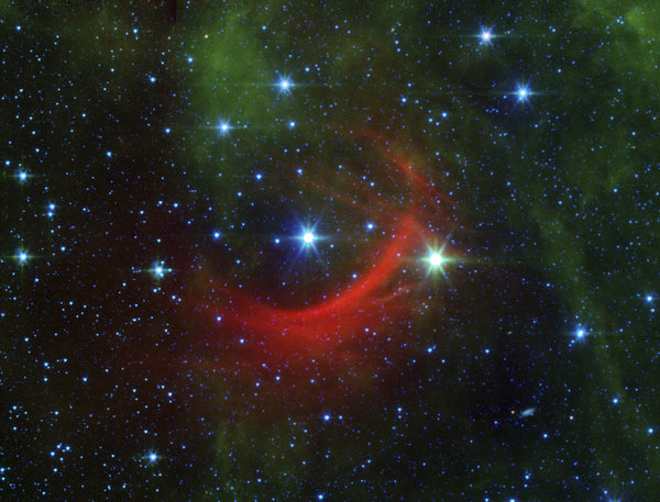 النجم السريع كابا كاسيوبيا، أو HD 2905، في الوسط، كما يمكنكم رؤية الموجة الصدمية التي نشأت عندما اصطدمت الحقول المغناطيسية ورياح الجسيمات المتدفقة من النجم بالغبار المنتشر غير المرئي بالعادة الذي يملئ الفراغ بين النجمي. حقوق الصورة: NASA/JPL-Caltech via AP