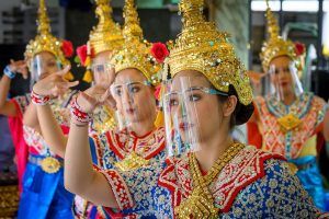 Traditional Thai dancers wearing protective face shields perform at the Erawan Shrine, which was reopened after the Thai government relaxed measures to combat the spread of the COVID-19 novel coronavirus, in Bangkok on May 4, 2020. - Thailand began easing restrictions related to the COVID-19 novel coronavirus on May 3 by allowing various businesses to reopen, but warned that the stricter measures would be re-imposed should cases increase again. (Photo by Mladen ANTONOV / AFP)