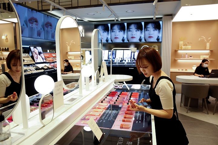 A woman shops at a cosmetic shop in a department store in Seoul, South Korea, July 2, 2020. Picture taken July 2, 2020. REUTERS/Heo Ran