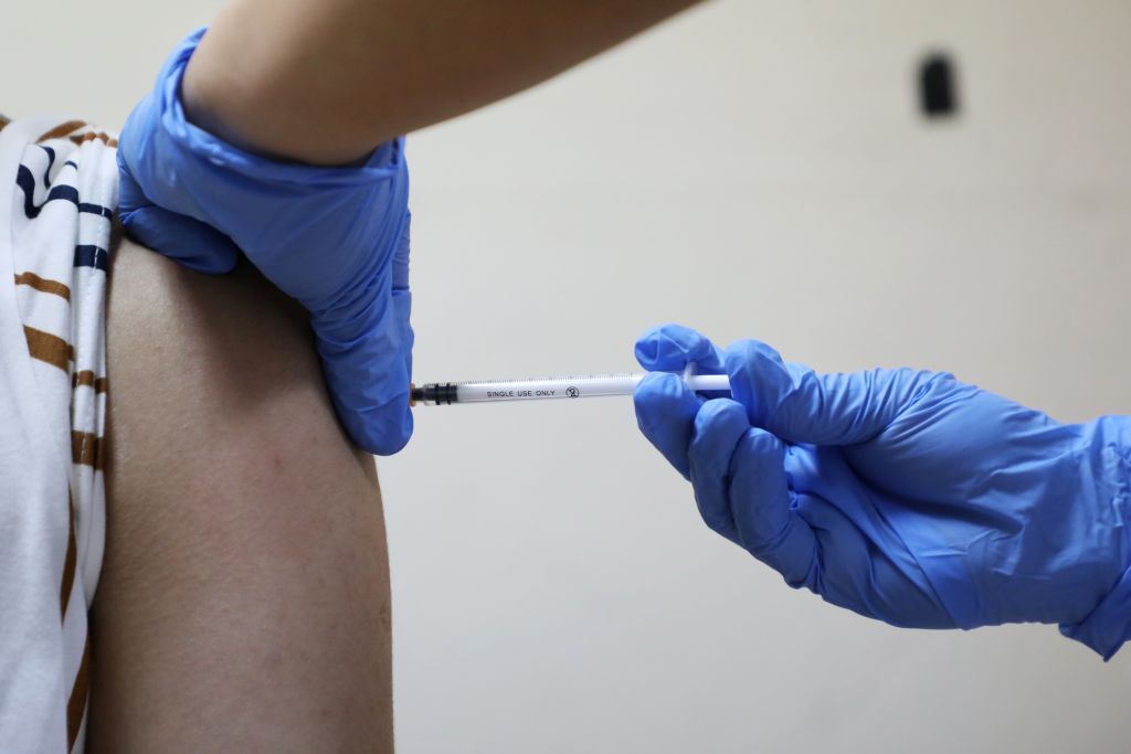 A medical worker receives a vaccine for the coronavirus disease (COVID-19) during a vaccination program at Kuala Lumpur Hospital in Kuala Lumpur, Malaysia March 1, 2021. REUTERS/Lim Huey Teng