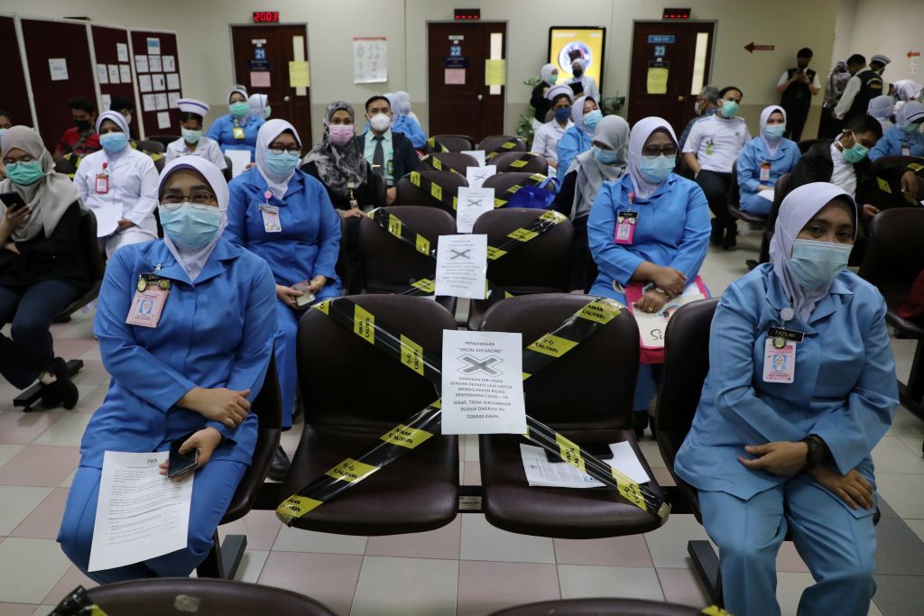 Medical workers wait to receive a vaccine for the coronavirus disease (COVID-19) during a vaccination program at Kuala Lumpur Hospital in Kuala Lumpur, Malaysia March 1, 2021. REUTERS/Lim Huey Teng